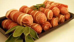 4 Stuffed sausages wrapped in streaky bacon.